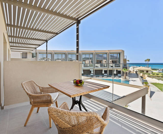 Ventale Island Breeze Resort Premium Double Sea View balcony with wooden table, two straw chairs and view